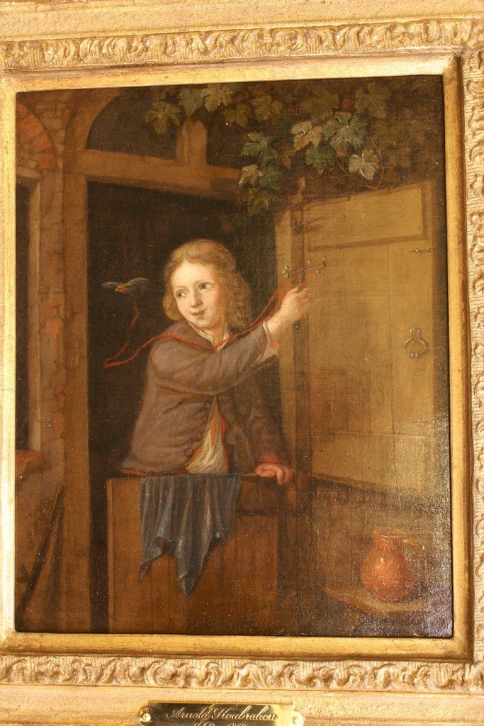Arnold Houbraken 1660-1719 - A boy standing in a doorway holding a finch on a string, Oil on canvas