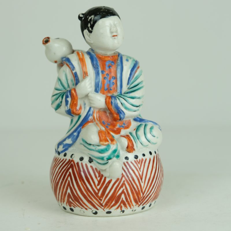 Japanese Kakiemon figure of a boy sitting on a drum., circa 1670-1690